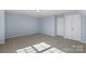 Expansive bedroom with a wall of closets, neutral carpet, and modern ceiling light at 152 Painted Bunting Dr, Troutman, NC 28166