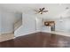 Spacious room featuring hardwood floors, staircase, and breakfast bar at 152 Painted Bunting Dr, Troutman, NC 28166