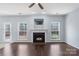 Living room features fireplace, hardwood floors, and view of the yard at 152 Painted Bunting Dr, Troutman, NC 28166