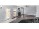 Open-concept living room features fireplace and access to the backyard at 152 Painted Bunting Dr, Troutman, NC 28166