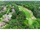 Aerial view of the neighborhood showcasing mature trees, golf course access, and the home's location at 16824 Ashton Oaks Dr, Charlotte, NC 28278