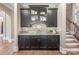 Chic bar area with dark cabinets, granite countertops, and convenient access to stairs at 16824 Ashton Oaks Dr, Charlotte, NC 28278
