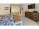Bedroom showcasing a large armoire, dresser with TV, bench and floral patterned bedspread at 16824 Ashton Oaks Dr, Charlotte, NC 28278