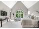 Bright bedroom with vaulted ceiling, large arched window, and cozy sitting area at 16824 Ashton Oaks Dr, Charlotte, NC 28278