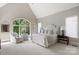 Bedroom with a neutral palette, including an arched window with a backyard view at 16824 Ashton Oaks Dr, Charlotte, NC 28278