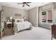 Cozy bedroom featuring neutral tones, plush carpet, and natural light creating a relaxing atmosphere at 16824 Ashton Oaks Dr, Charlotte, NC 28278