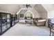 Large bonus room with vaulted ceilings, comfortable seating, and ample display shelving, perfect for relaxing and entertaining at 16824 Ashton Oaks Dr, Charlotte, NC 28278