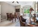 Bright dining area with natural light, wood table, and a calendar accenting the neutral tones of the room at 16824 Ashton Oaks Dr, Charlotte, NC 28278