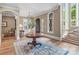 Bright foyer featuring hardwood floors, staircase, a charming rug, and entry to formal rooms at 16824 Ashton Oaks Dr, Charlotte, NC 28278