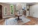 Elegant foyer featuring hardwood floors, staircase, beautiful architectural details, and a decorative rug at 16824 Ashton Oaks Dr, Charlotte, NC 28278