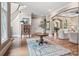 Inviting foyer with staircase, hardwood floors, an area rug, and seamless transition to the living room at 16824 Ashton Oaks Dr, Charlotte, NC 28278