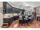 Modern kitchen with dark cabinets, stone countertops, and a breakfast bar, creating a stylish and functional space at 16824 Ashton Oaks Dr, Charlotte, NC 28278