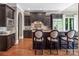 Stylish kitchen featuring dark cabinetry, granite countertops, and stainless steel appliances at 16824 Ashton Oaks Dr, Charlotte, NC 28278