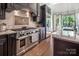 Gourmet kitchen with a professional-grade range, custom cabinets, and island with seating at 16824 Ashton Oaks Dr, Charlotte, NC 28278