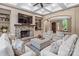 Elegant living room featuring a stone fireplace, coffered ceilings, and comfortable seating at 16824 Ashton Oaks Dr, Charlotte, NC 28278