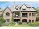 Spacious rear elevation featuring brickwork, large patio area and multiple outdoor seating arrangements at 16824 Ashton Oaks Dr, Charlotte, NC 28278