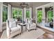 Cozy sitting room with natural light, comfortable seating, and access to outdoor patio, creating a relaxing retreat at 16824 Ashton Oaks Dr, Charlotte, NC 28278