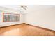 Minimalist bedroom featuring hardwood floors, large window and tray ceiling at 171 Agnew Rd, Mooresville, NC 28117