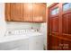 Functional laundry room with cabinets for storage and easy access to the exterior at 171 Agnew Rd, Mooresville, NC 28117