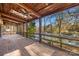 Covered back porch with a fan overlooking the backyard and the lake at 171 Agnew Rd, Mooresville, NC 28117