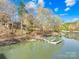 Tranquil lake with a dock and lush greenery, showcasing waterside serenity at 171 Agnew Rd, Mooresville, NC 28117