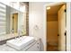 Modern bathroom featuring a vessel sink, granite countertop, wood accent wall, and a door to the toilet and shower at 1780 Lumpkin Cir, Rock Hill, SC 29732