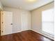 Bright bedroom features hardwood floors, a window letting in natural light, and a closet with bifold doors at 1780 Lumpkin Cir, Rock Hill, SC 29732