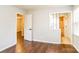 Bright bedroom featuring wood floors and a view of an adjacent bathroom and hallway at 1780 Lumpkin Cir, Rock Hill, SC 29732