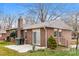 Exterior view of a brick home with a patio, sliding glass doors, and mature trees in a landscaped yard at 1780 Lumpkin Cir, Rock Hill, SC 29732