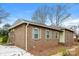 Side view of a brick home featuring multiple windows, a paved driveway, and a tidy landscape at 1780 Lumpkin Cir, Rock Hill, SC 29732