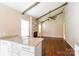Open-concept living space featuring a brick fireplace, hardwood floors, and a view of the kitchen at 1780 Lumpkin Cir, Rock Hill, SC 29732