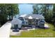 Breathtaking aerial view of a luxurious waterfront home featuring manicured grounds and serene lake views at 180 Willow Point Rd, Troutman, NC 28166