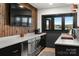 Modern bar area featuring wood paneling, stainless steel appliances, and picturesque lake views at 180 Willow Point Rd, Troutman, NC 28166