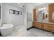 Bright bathroom featuring marble floors and walls, a soaking tub, shower, and natural wood vanity at 180 Willow Point Rd, Troutman, NC 28166