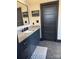 Chic bathroom with a stylish vanity, vessel sink, modern fixtures, and a unique patterned floor at 180 Willow Point Rd, Troutman, NC 28166