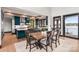 Open-concept dining area with modern table, chairs, and views to the kitchen at 180 Willow Point Rd, Troutman, NC 28166