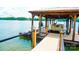 Lake house includes a private covered dock with a boat and jet ski lift at 180 Willow Point Rd, Troutman, NC 28166