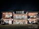 Stunning two-story home featuring a modern design, multiple balconies, and great outdoor living spaces at 180 Willow Point Rd, Troutman, NC 28166