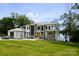 Stunning modern home with stone accents, manicured lawn, and lush trees create an inviting curb appeal at 180 Willow Point Rd, Troutman, NC 28166