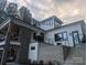 Beautiful home exterior with stone accents, multi-level deck, and cable railing at 180 Willow Point Rd, Troutman, NC 28166