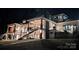Expansive home featuring multiple stories, covered patios, and stone accents for elegant outdoor living at 180 Willow Point Rd, Troutman, NC 28166
