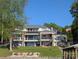 Expansive modern lake house with multiple levels, outdoor decks, and beachfront access, perfect for waterfront living at 180 Willow Point Rd, Troutman, NC 28166