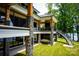 Spacious home features a multi-level deck with cable railing, and stone pillar accents at 180 Willow Point Rd, Troutman, NC 28166
