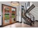 Bright foyer with wood-framed glass doors and modern staircase at 180 Willow Point Rd, Troutman, NC 28166