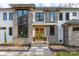 Grand home featuring a stone facade, wooden door, and decorative fall pumpkins and plants at 180 Willow Point Rd, Troutman, NC 28166