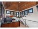A stylish home office with a custom wood ceiling, a view of the lake, and black trim windows at 180 Willow Point Rd, Troutman, NC 28166