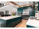Gourmet kitchen boasts dark green cabinets, a large marble island, stainless steel appliances, and modern pendant lighting at 180 Willow Point Rd, Troutman, NC 28166