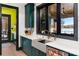 Modern kitchen with bold green cabinets, stainless steel appliances, and views of the lake at 180 Willow Point Rd, Troutman, NC 28166