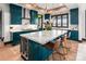 Modern kitchen featuring a large island with marble countertop, dark green cabinets, and stainless steel fixtures at 180 Willow Point Rd, Troutman, NC 28166