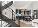 Modern kitchen featuring teal cabinets, marble countertops, and a stainless steel staircase at 180 Willow Point Rd, Troutman, NC 28166